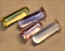 Rare earth doped glasses produced by sol-gel synthesis. Rare earth doping from left to right: Pr3+, Nd3+, Er3+, Eu3+.